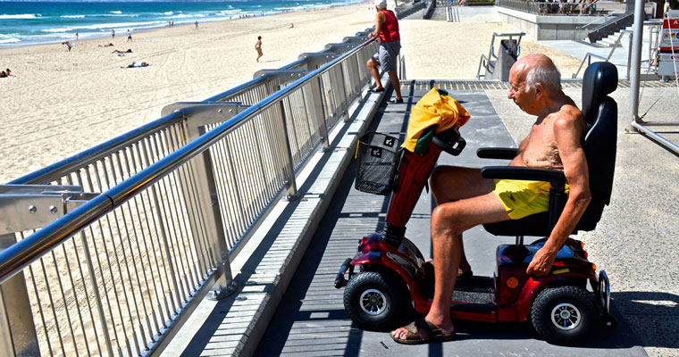 P-independent-Man-at-beach-in-motorised-chair